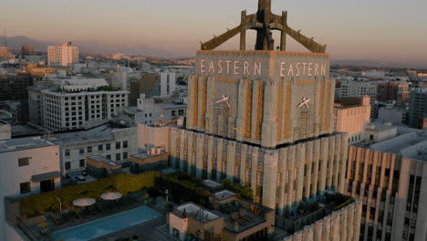 eastern columbia building and rooftop pool at sunset in downtown los angeles