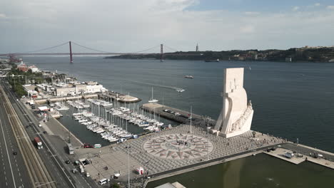 drone shot flying over historical monument in lisbon, portugal