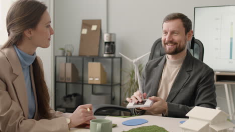 businessman explaining wind turbine model during a meeting in the office