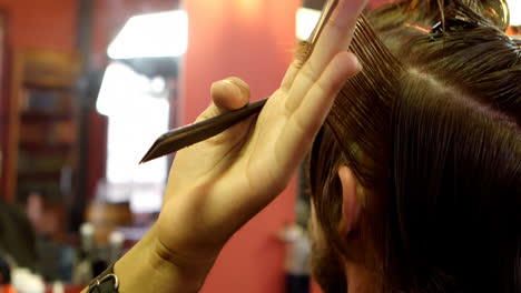 man getting his hair trimmed with scissor 4k