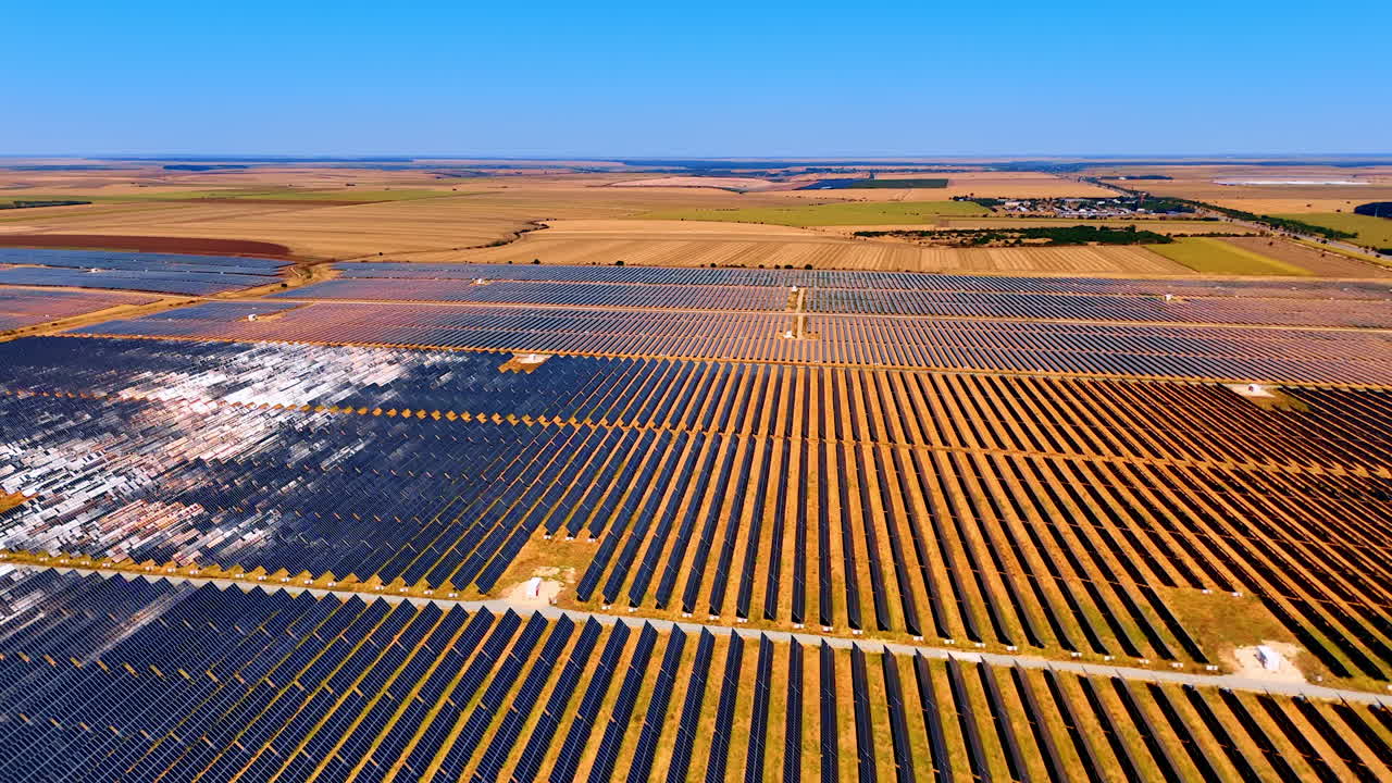 Huge field covered with solar panels. Drone flight over the countryside used for production of renewable energy