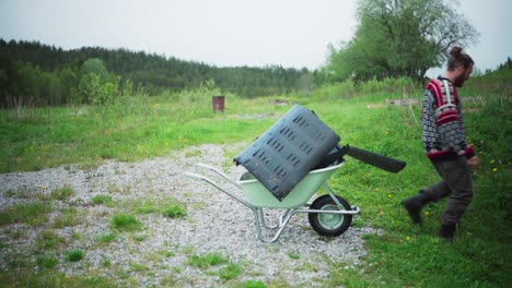 Man-Loading-Wheelbarrow-With-Plastic-Waste.---static