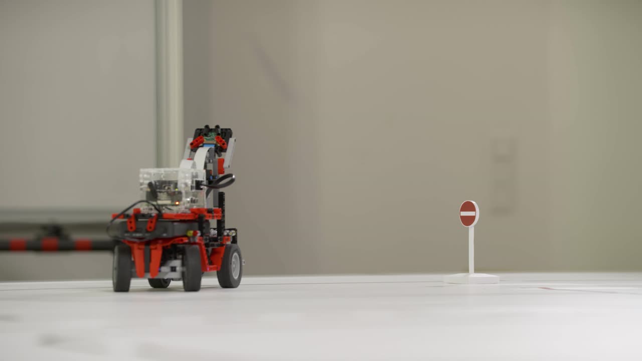 A self-driving line-following robot from a student project drives over the drawn lines of a street map and turns around after sensing a stop sign