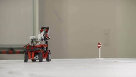 a self-driving line-following robot from a student project drives over the drawn lines of a street map and turns around after sensing a stop sign