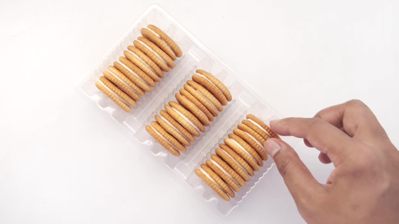 Cream-filled cookies in a plastic container