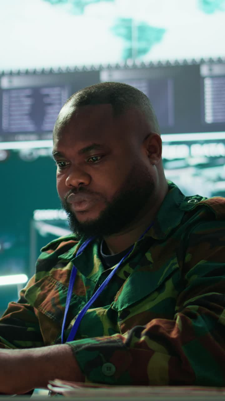Vertical Video Team of military professionals in control center monitors satellite intelligence