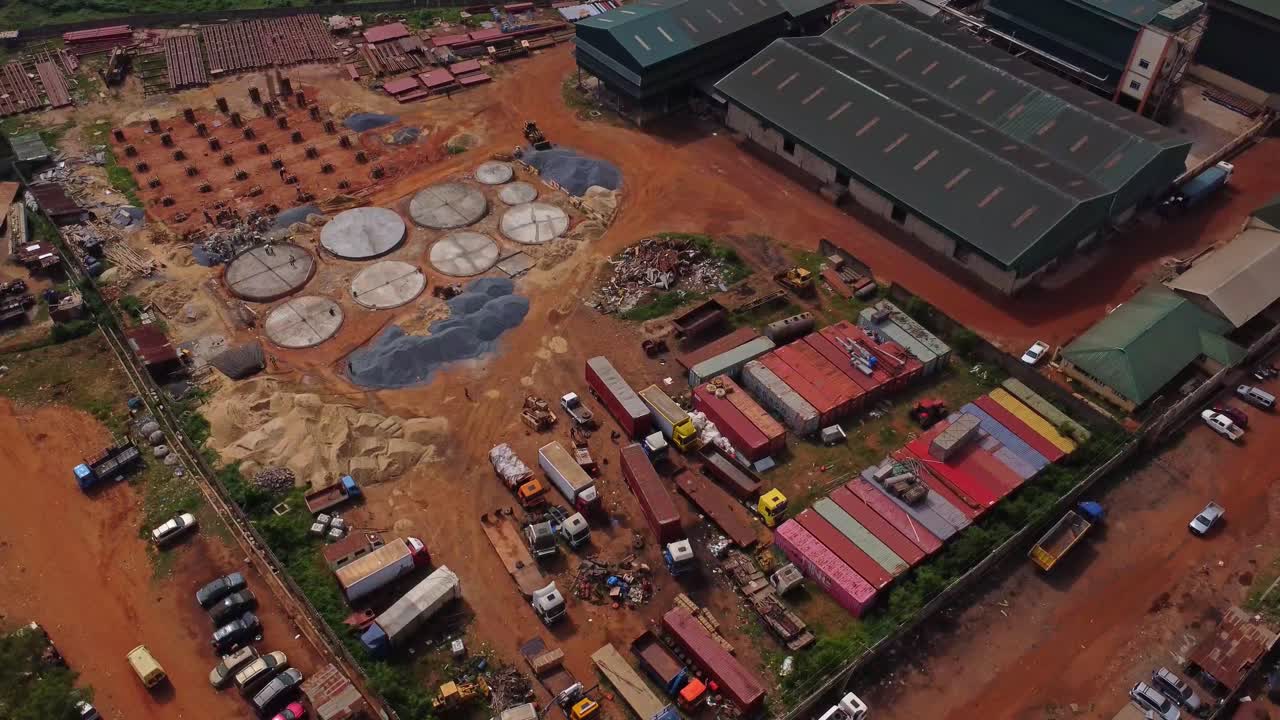 High angle view of a large industrial zone with a factory, warehouses and a building under construction in Ibadan, Nigeria