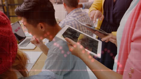 graph and data points animation over people working with tablets and laptops