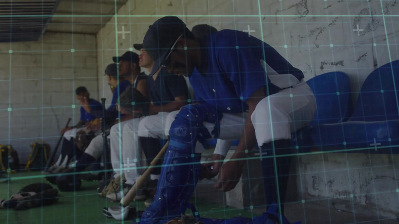 Catcher starting fastening blue shin guard, reaching bat team sitting bench preparing play baseball