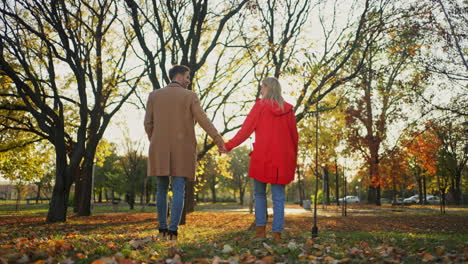 couple walking in a park during autumn