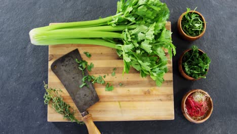 Herbs-and-wooden-board-on-concrete-background