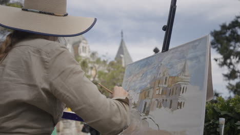 woman artist painting outdoors