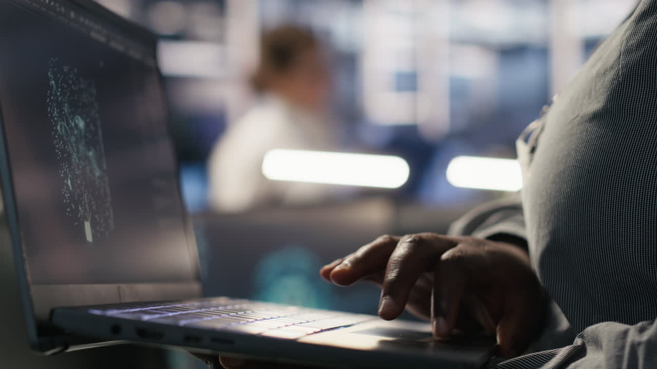 Vertical video Close up of data center engineer using laptop to monitor AI LLM visualization