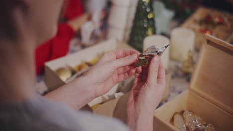 woman with bird ornament at home