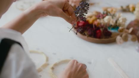 creating a floral arrangement with dried flowers