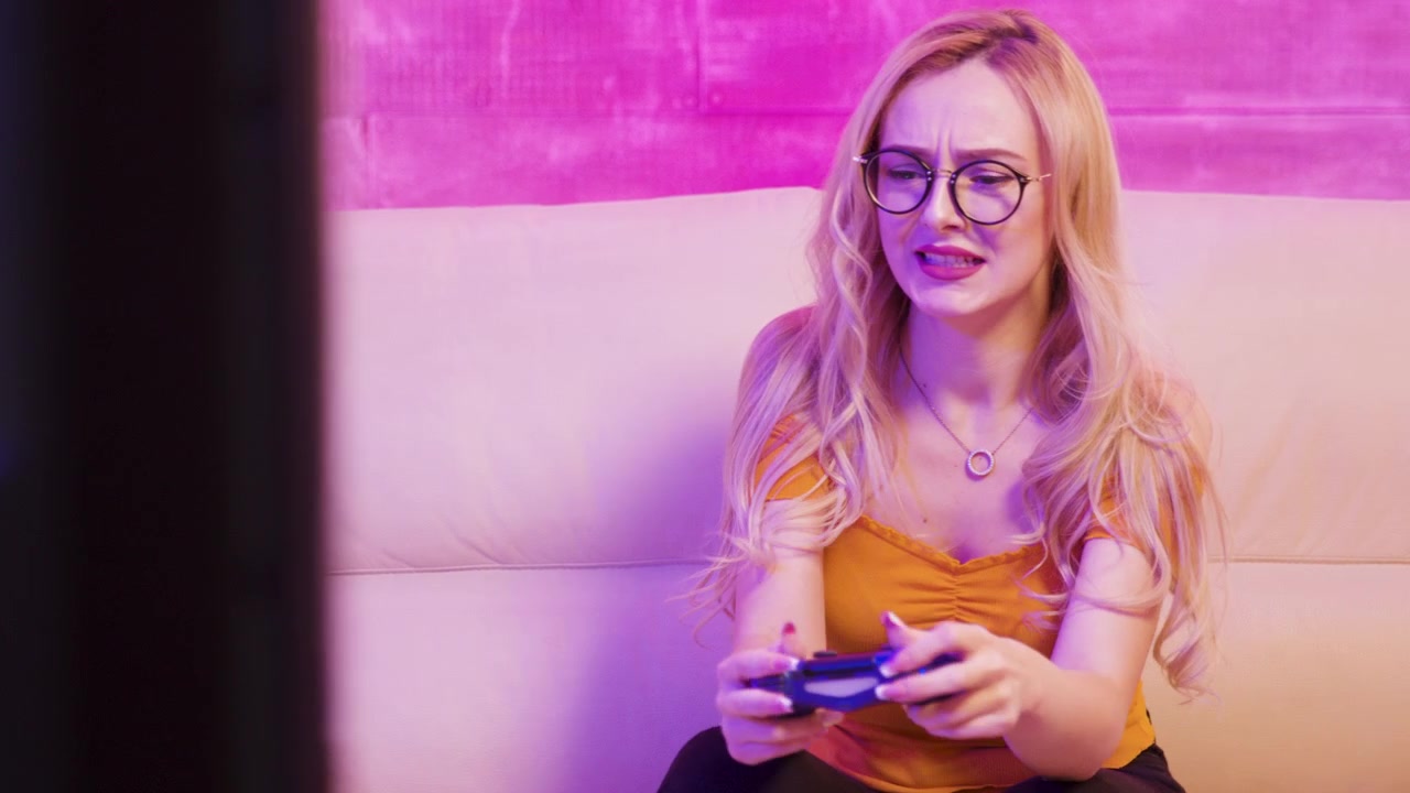 Upset blonde woman reacts after losing a console game