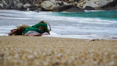 rubbish carried by waves of sea on the shoreline