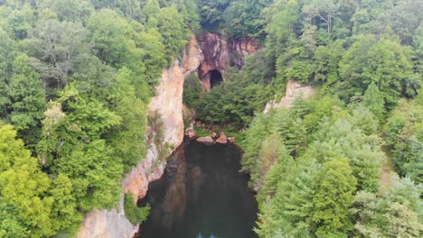 4K-Drone-Video-of-Beautiful-Mountain-Pond-Surrounded-by-Trees-and-Cliffs-at-Emerald-Village-near-Little-Switzerland,-NC-on-Summer-Day-2