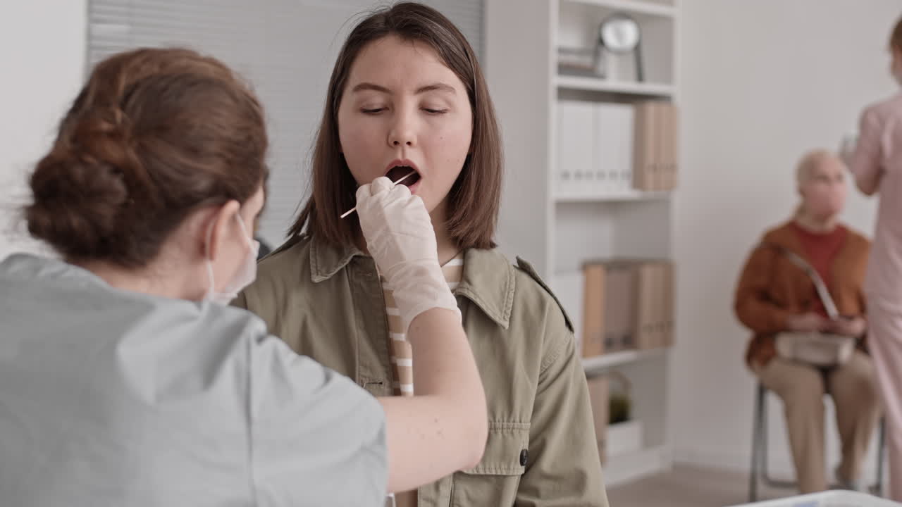 Woman Opening Mouth for DNA-Sample Collection