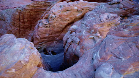 a cinematic aerial shot reveals the labyrinthine rock formations of glen canyon, set against the vast lake powell.