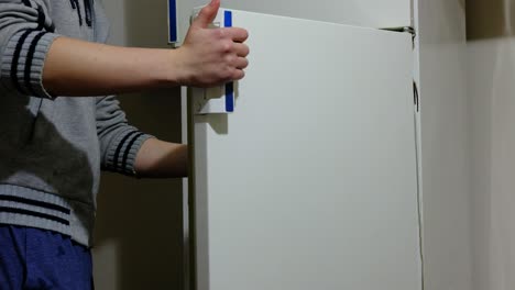 man opening refrigerator