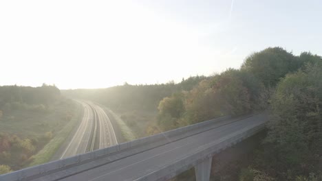 steady shot of sunrise or sunset at an overpass in nature