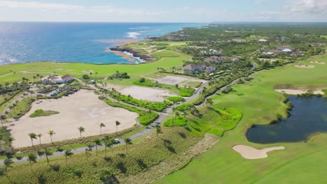 drone shot of beautiful golf court and natural lake near coastline of punta cana during summer