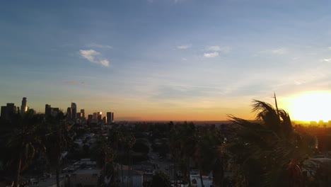 Aerial-view-over-the-Elysian-Park-towards-skyscrapers-in-sunny-Los-Angeles,-USA