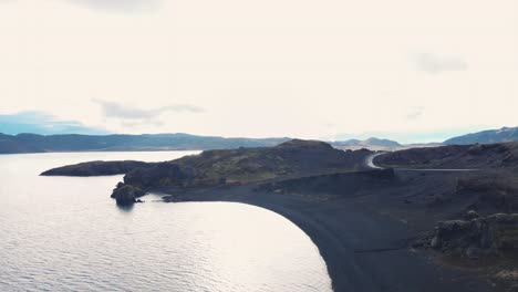 road along black volcanic beaches of kleifarvatn lake, iceland, drone