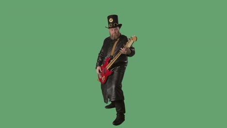 a bearded man in a long leather coat and an irish-style hat plays the red guitar. rock musician plays bass guitar in studio on green screen chroma key. slow motion