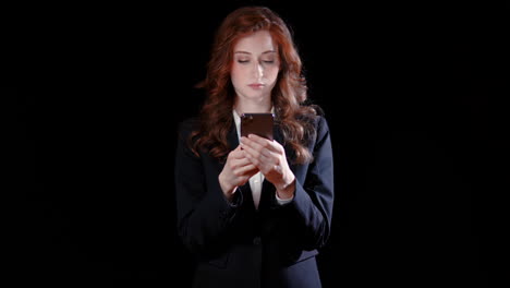 -A-caucasian-businesswoman-texting-on-cell-phone,-neutral-expression