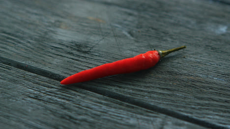 Single-red-chili-pepper-on-table