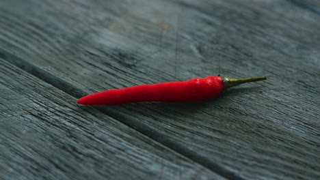 single red chili pepper on table