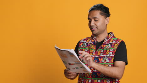 Worker-looking-over-paperwork-graphs,-studio-background