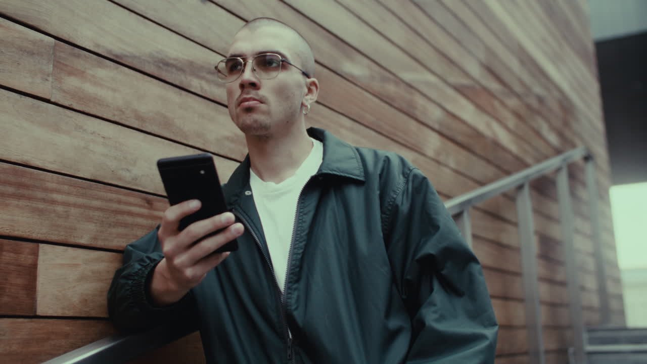 Young Man on Stairs Using Smartphone