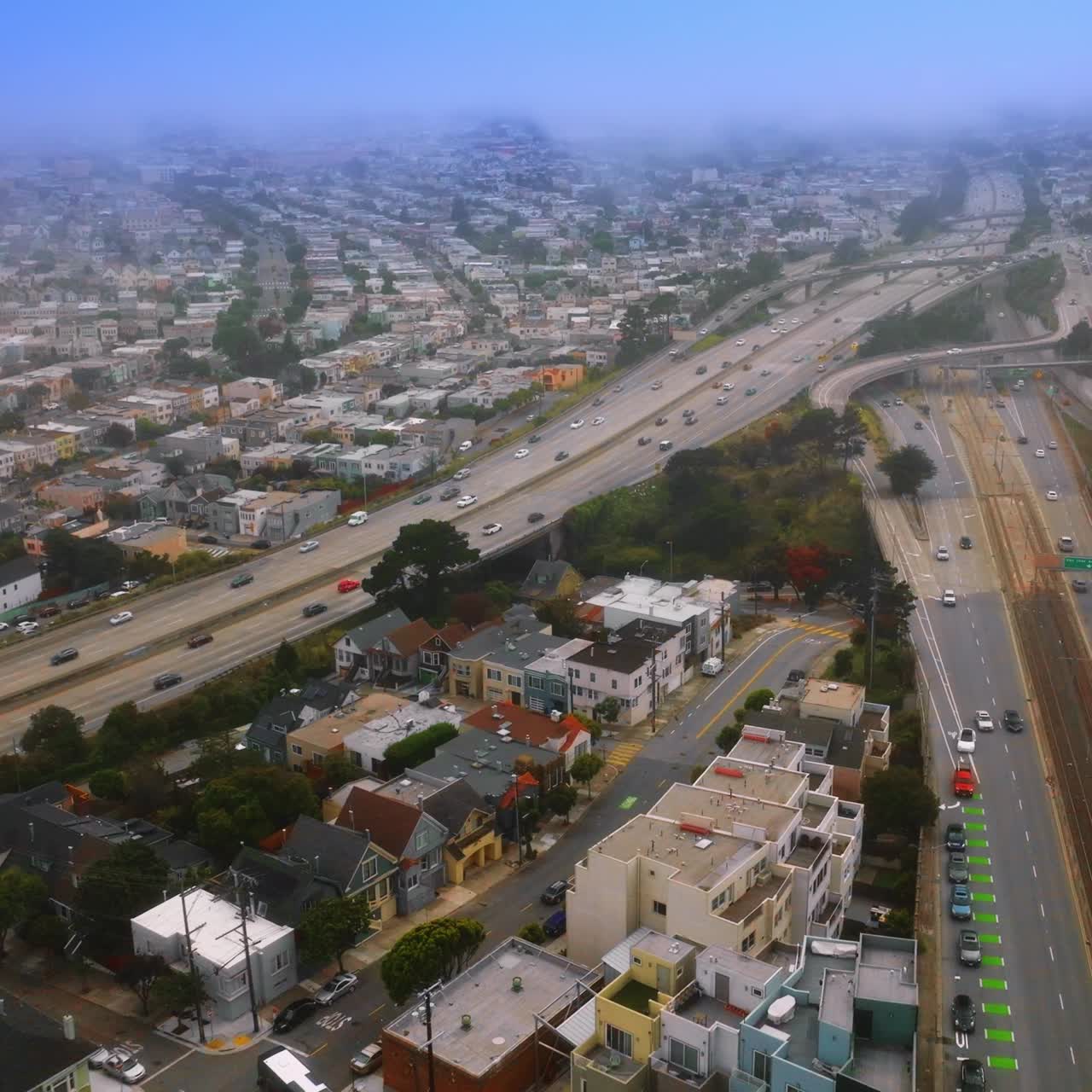 Lovely houses in the city architecture of San Francisco, California, USA. Densely built city streets with roads and busy traffic