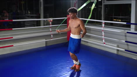 young boxer jumping rope in the boxing ring