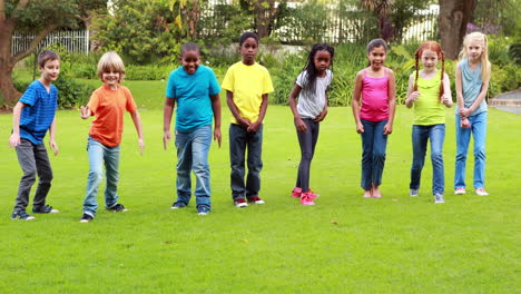 Row-of-cute-pupils-racing-on-the-grass