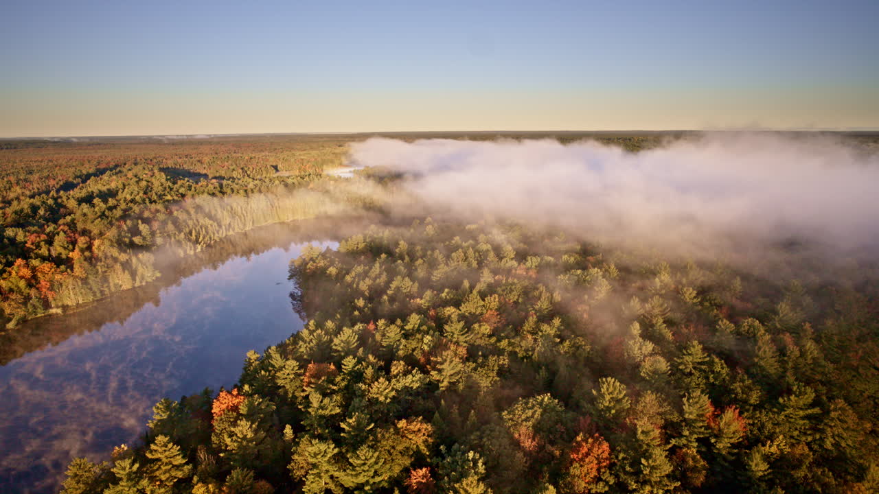 Early morning drone shot revealing mist rising off the water