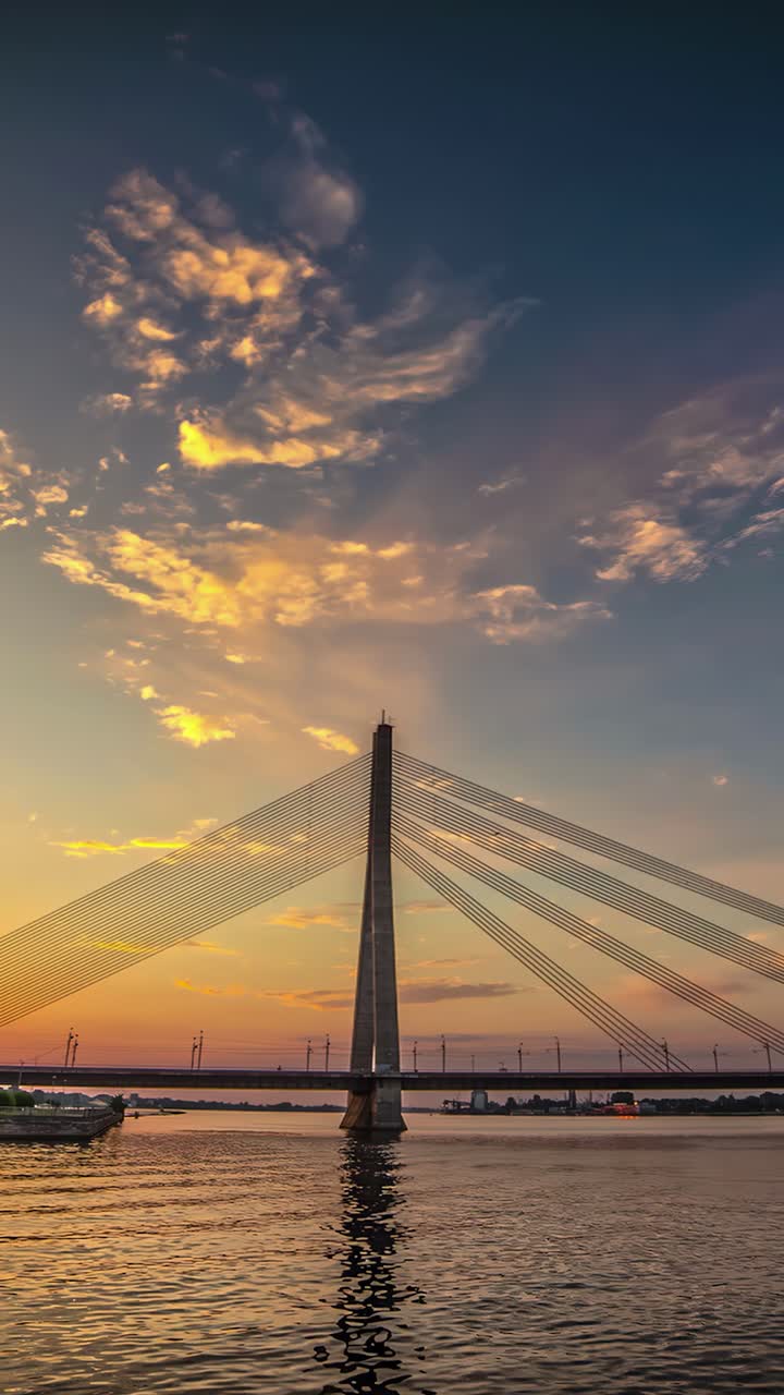 Transportation over Vansu bridge in Riga at sunset. Vertical time lapse