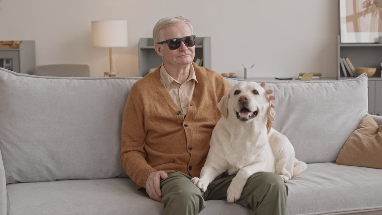 Blind Senior Man with Labrador Retriever at Home