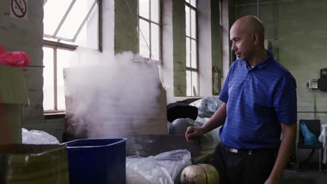 mixed race man working at a hat factory