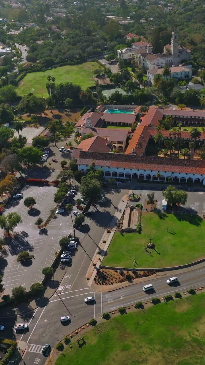 Sunny scenery of a green city with rich architecture and lots of greenery. Footage over the traffic roads of Santa Barbara, California, USA. Vertical video
