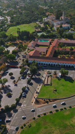 sunny scenery of a green city with rich architecture and lots of greenery. footage over the traffic roads of santa barbara, california, usa. vertical video