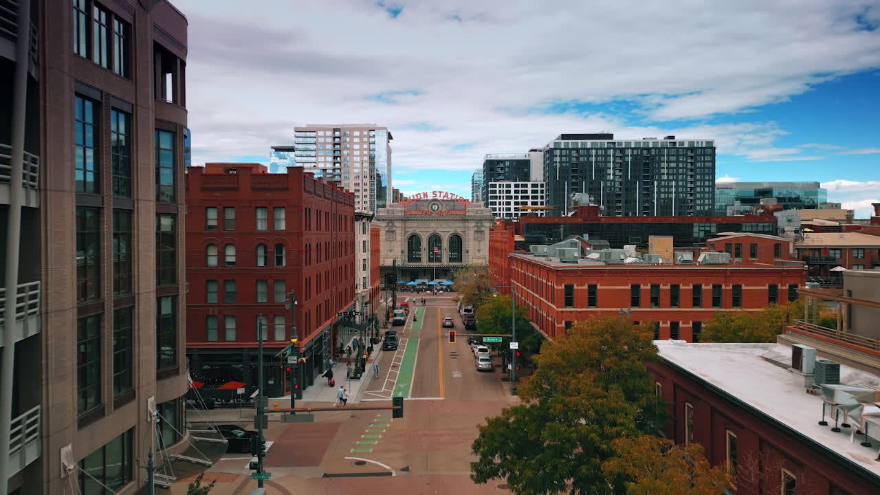 Denver, USA, 24 August 2025: Footage over the wide street among the multi-storied buildings. Approaching the building of Union Station in Denver, Colorado, USA