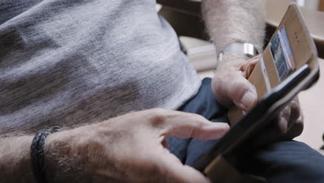 an elderly man is using his phone