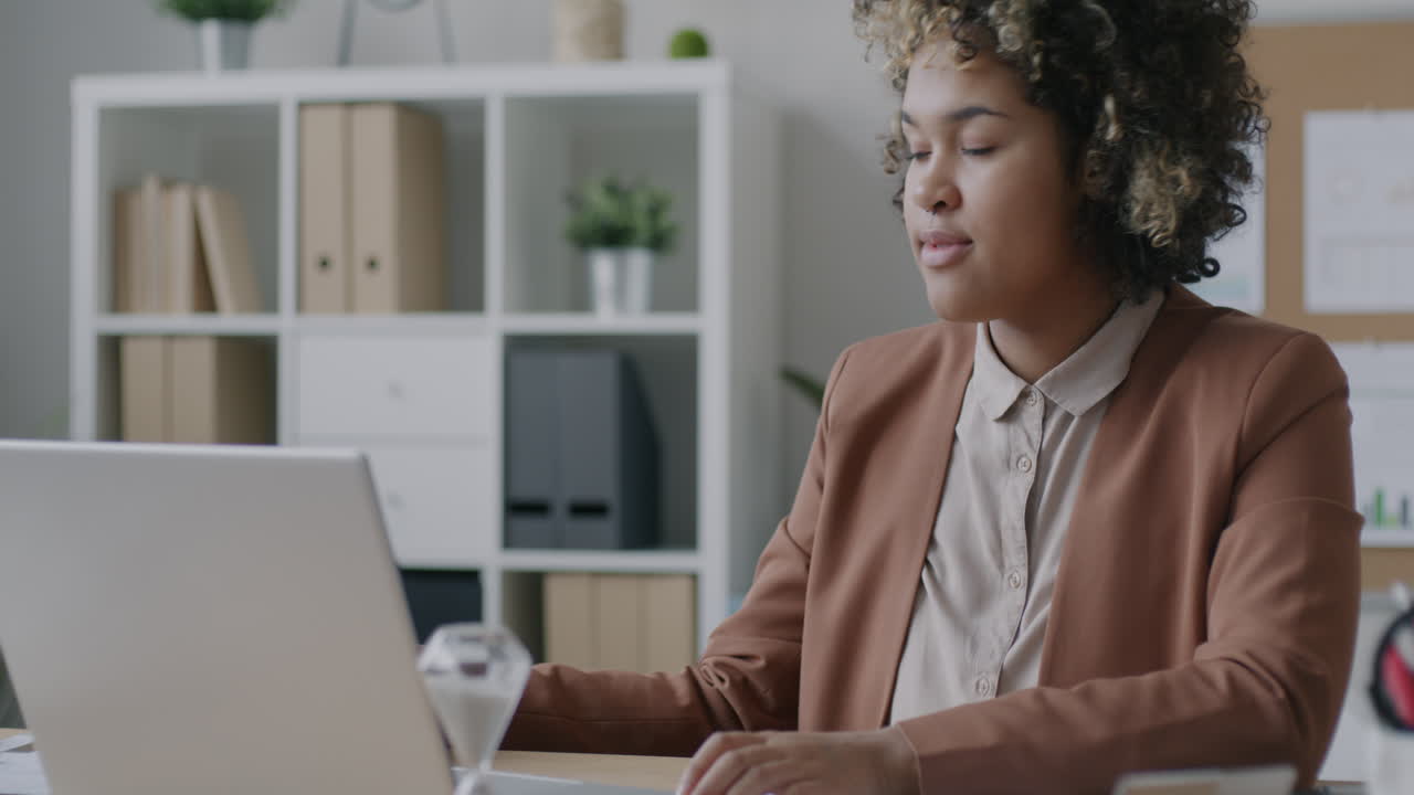 Woman Drinking Coffee in Modern Office