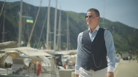 man walking along a harbor