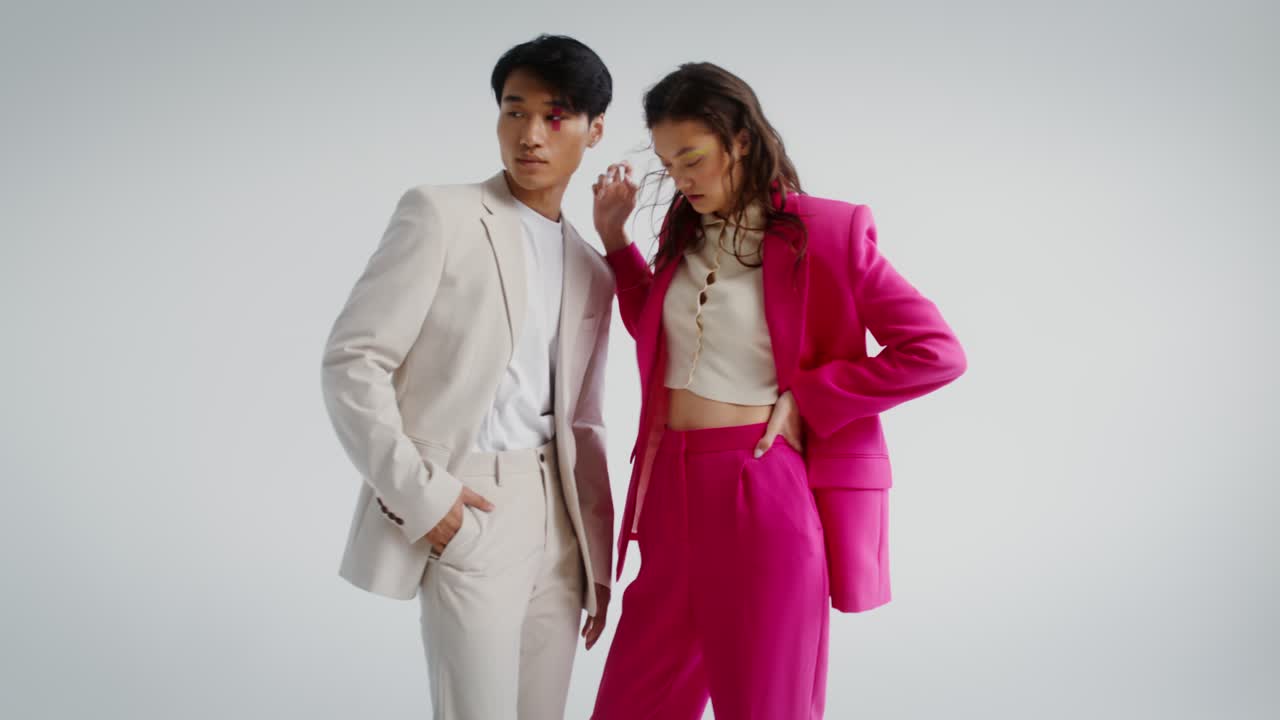 Fashionable couple in suits posing