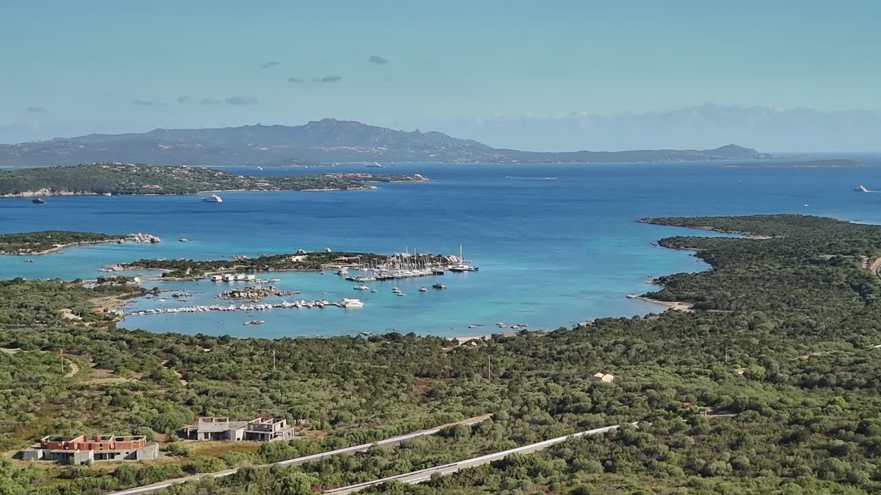 Views of a coastal marina in Sardinia near the island's lush hills